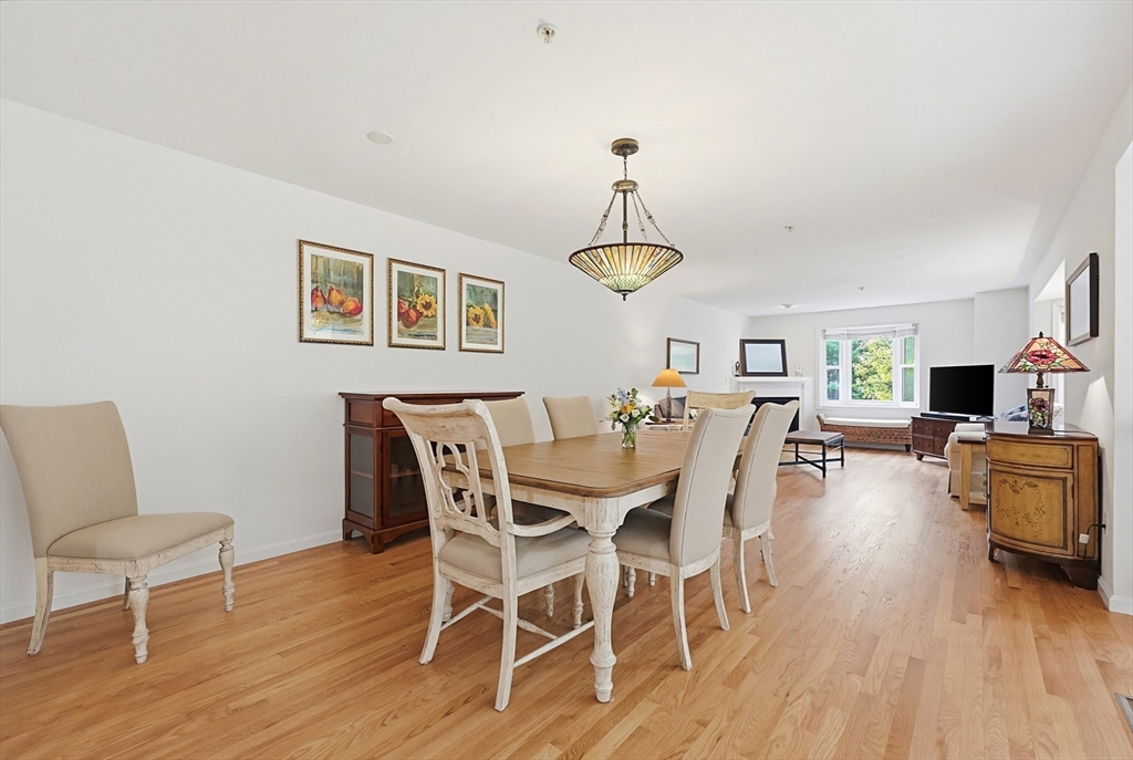 3002 Maple Brook Road, Unit 3002 Bellingham, MA 02019 - Photo 8 of 42 a view of a dining room with furniture wooden floor and chandelier