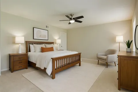 a bathroom with a granite countertop sink mirror vanity and toilet