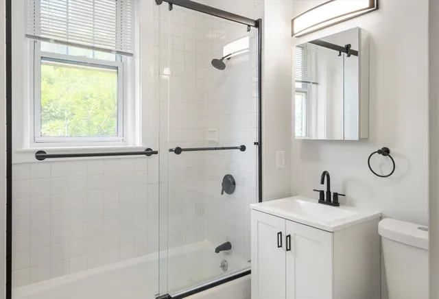 a bathroom with a shower sink and mirror