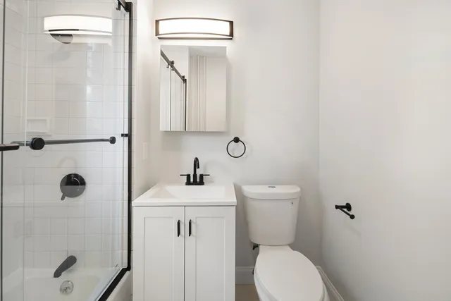 a bathroom with a toilet sink and shower