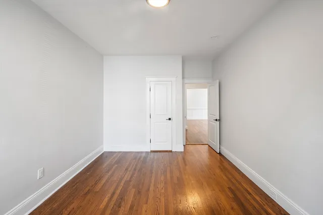 a view of a room with wooden floor