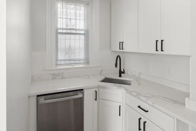a view white cabinets and sink