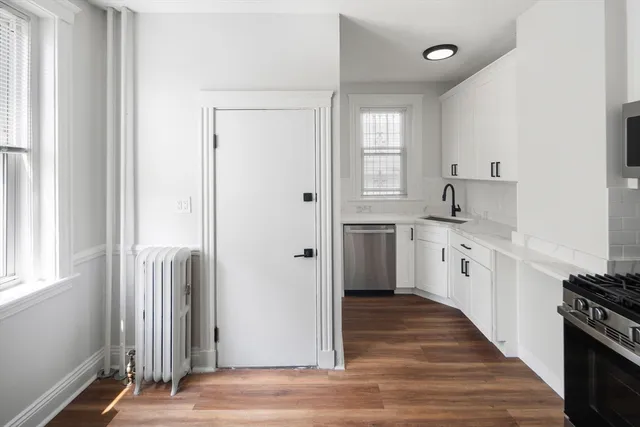 a kitchen with stainless steel appliances granite countertop a refrigerator and a sink