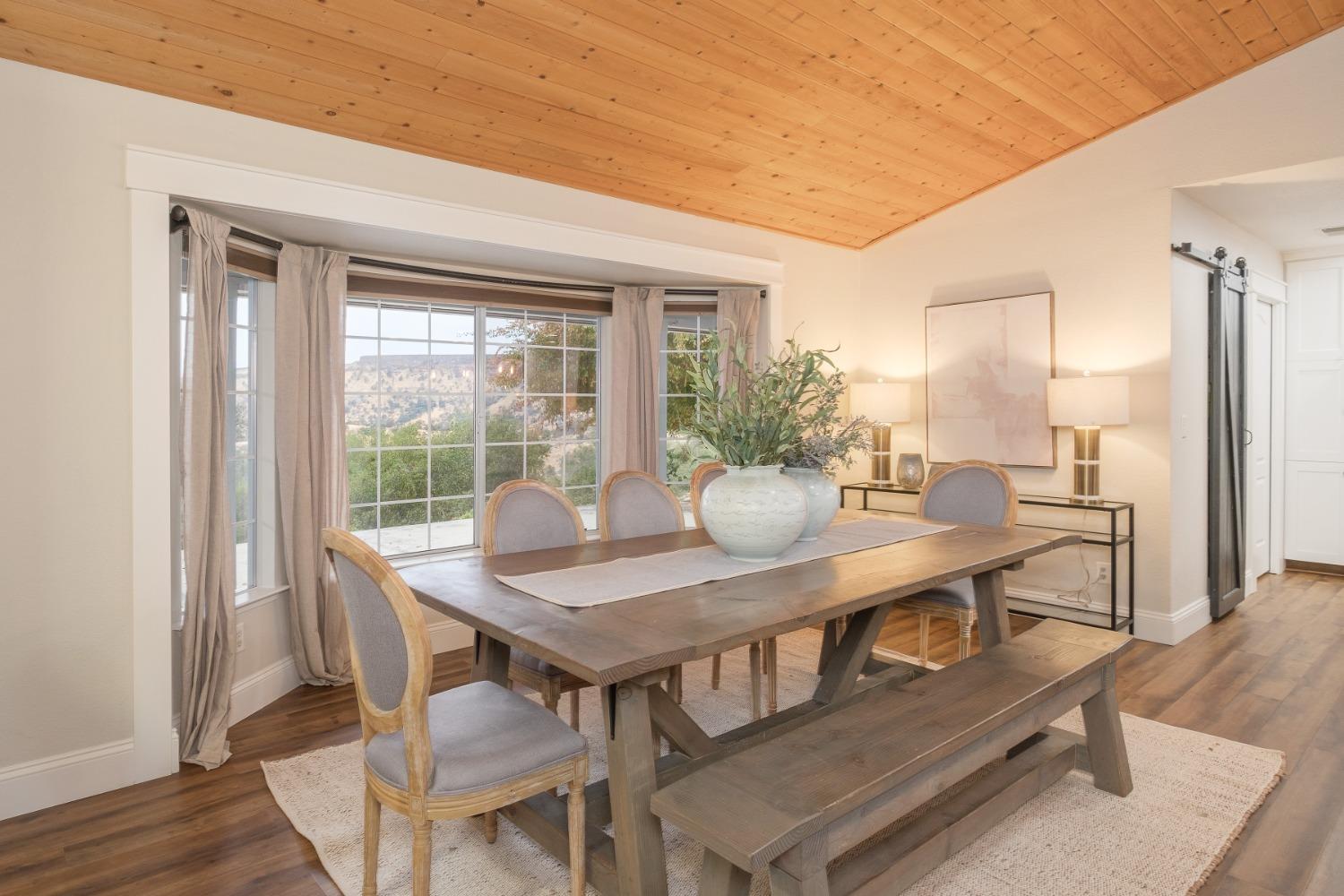 25390 White Thorne Road Clovis, CA 93619 - Photo 11 of 50 a view of a dining room with furniture window and wooden floor