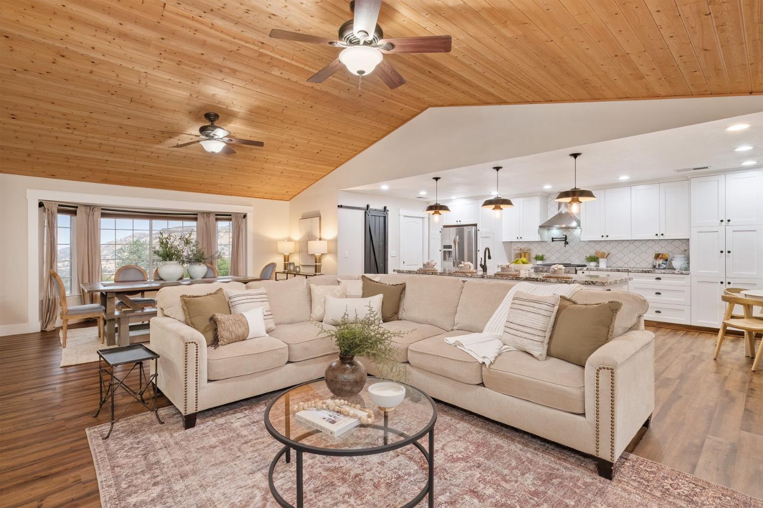 25390 White Thorne Road Clovis, CA 93619 - Photo 14 of 50 a living room with furniture kitchen view and a chandelier
