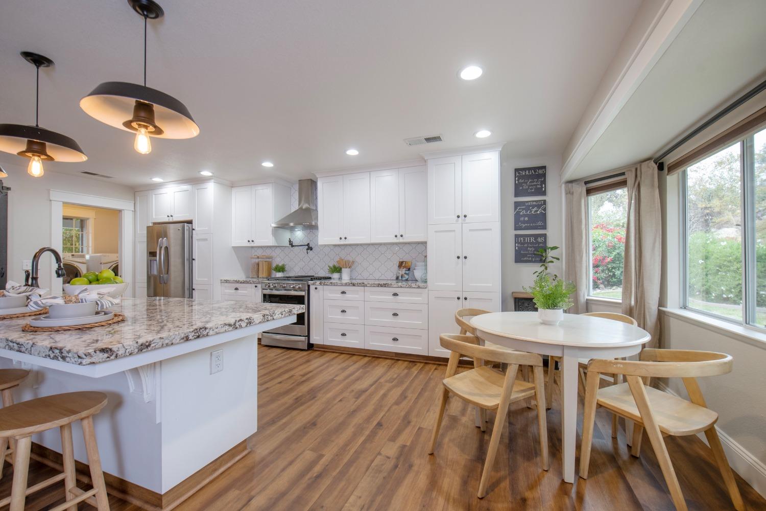 25390 White Thorne Road Clovis, CA 93619 - Photo 19 of 50 a large kitchen with a table and chairs