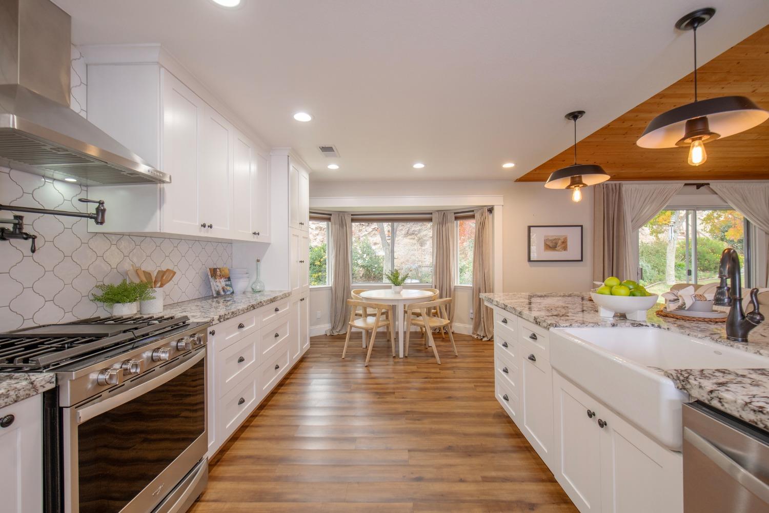 25390 White Thorne Road Clovis, CA 93619 - Photo 2 of 50 a kitchen with sink stove and cabinets