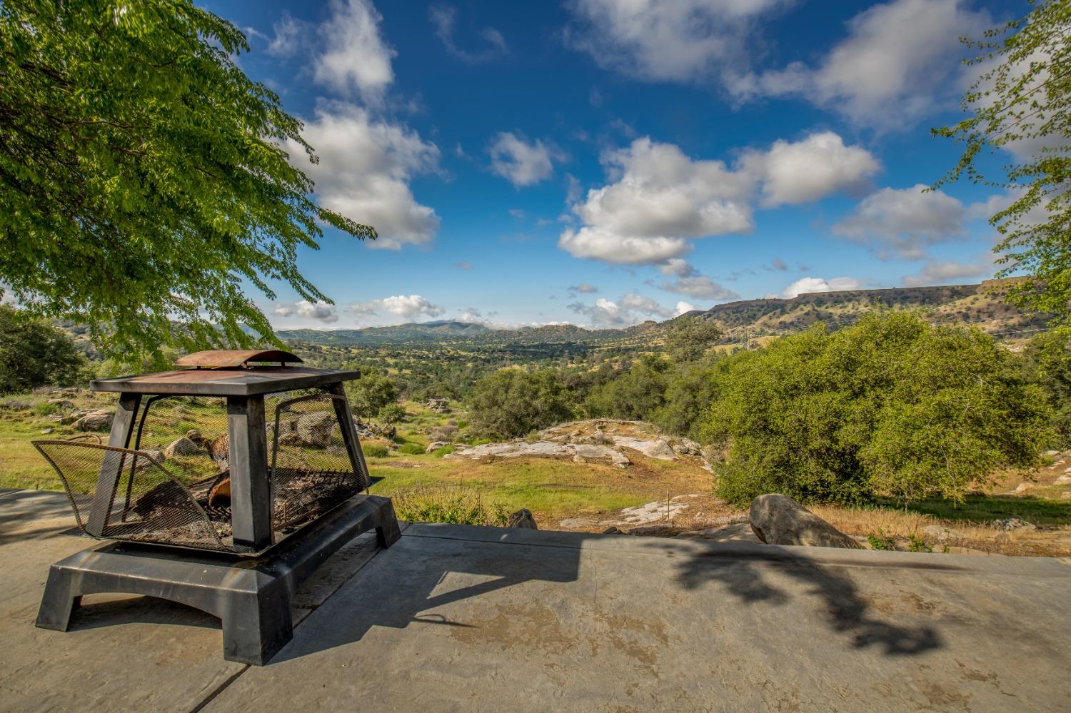 25390 White Thorne Road Clovis, CA 93619 - Photo 41 of 50 a view of a backyard with lawn chairs under an umbrella
