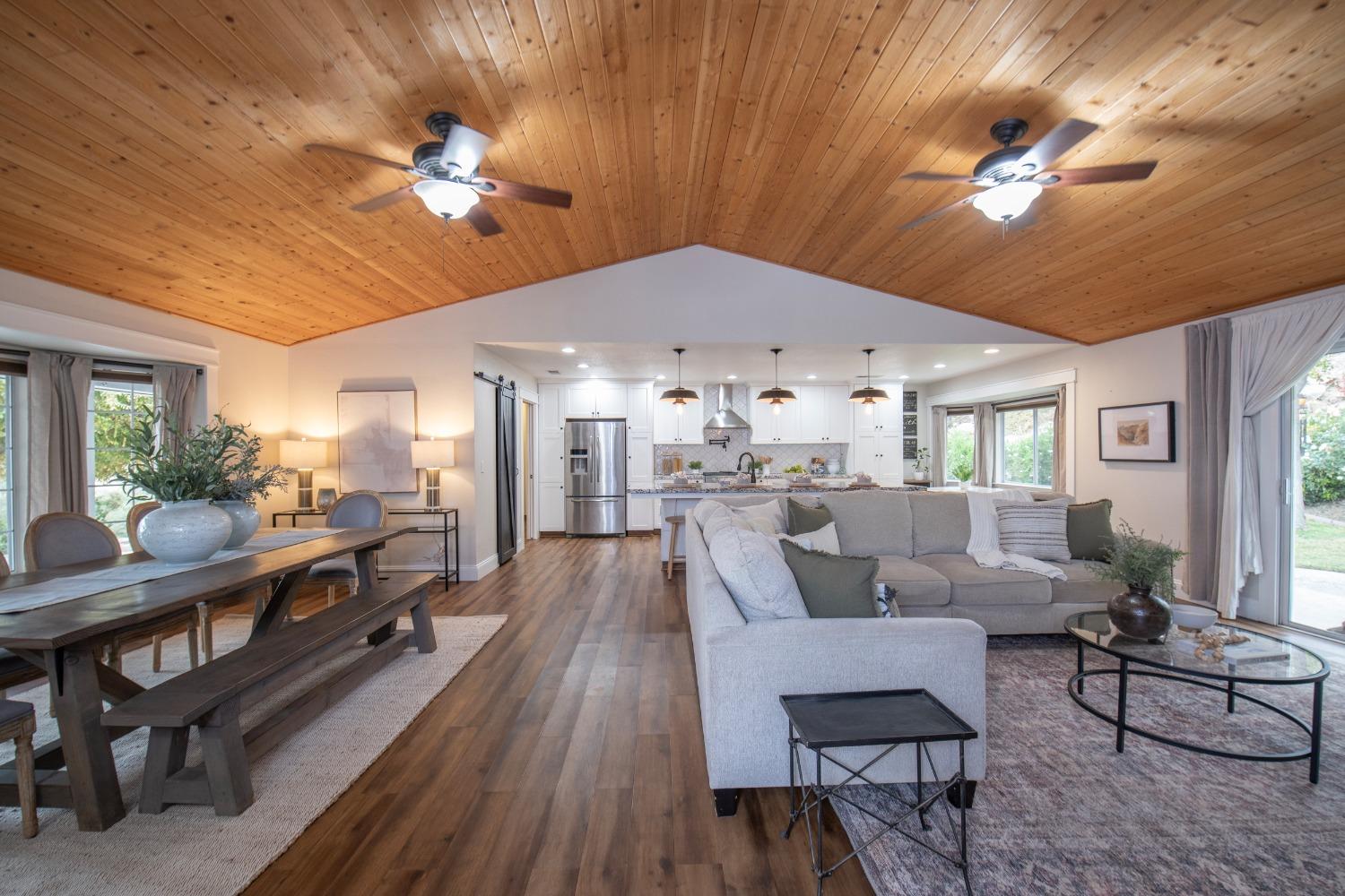 25390 White Thorne Road Clovis, CA 93619 - Photo 10 of 50 a living room with lots of furniture and a chandelier