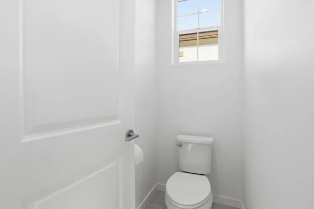 a white toilet sitting next to a bath tub