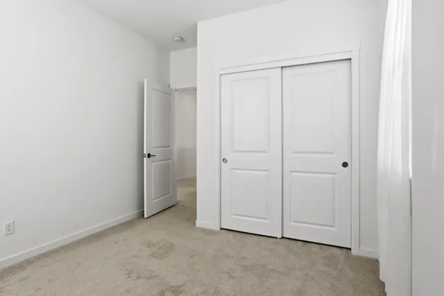 an empty room with closet area