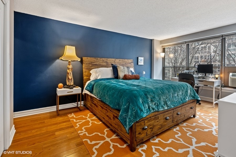 2930 North Sheridan Road, Unit 312 Chicago, IL 60657 - Photo 8 of 14 a bedroom with a bed and window