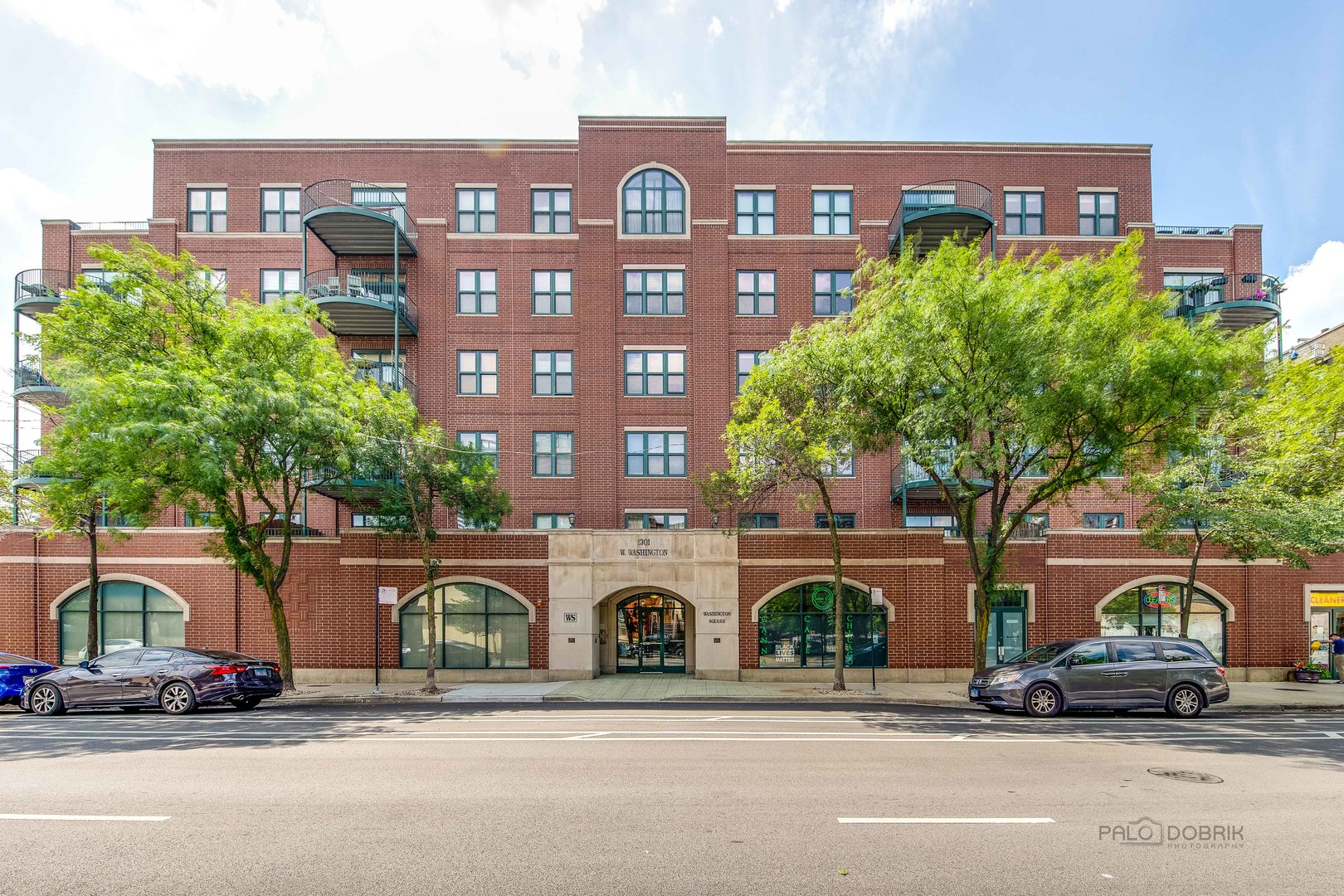 1301 West Washington Boulevard, Unit 309 Chicago, IL 60607 - Photo 1 of 23 a front view of a building with garden
