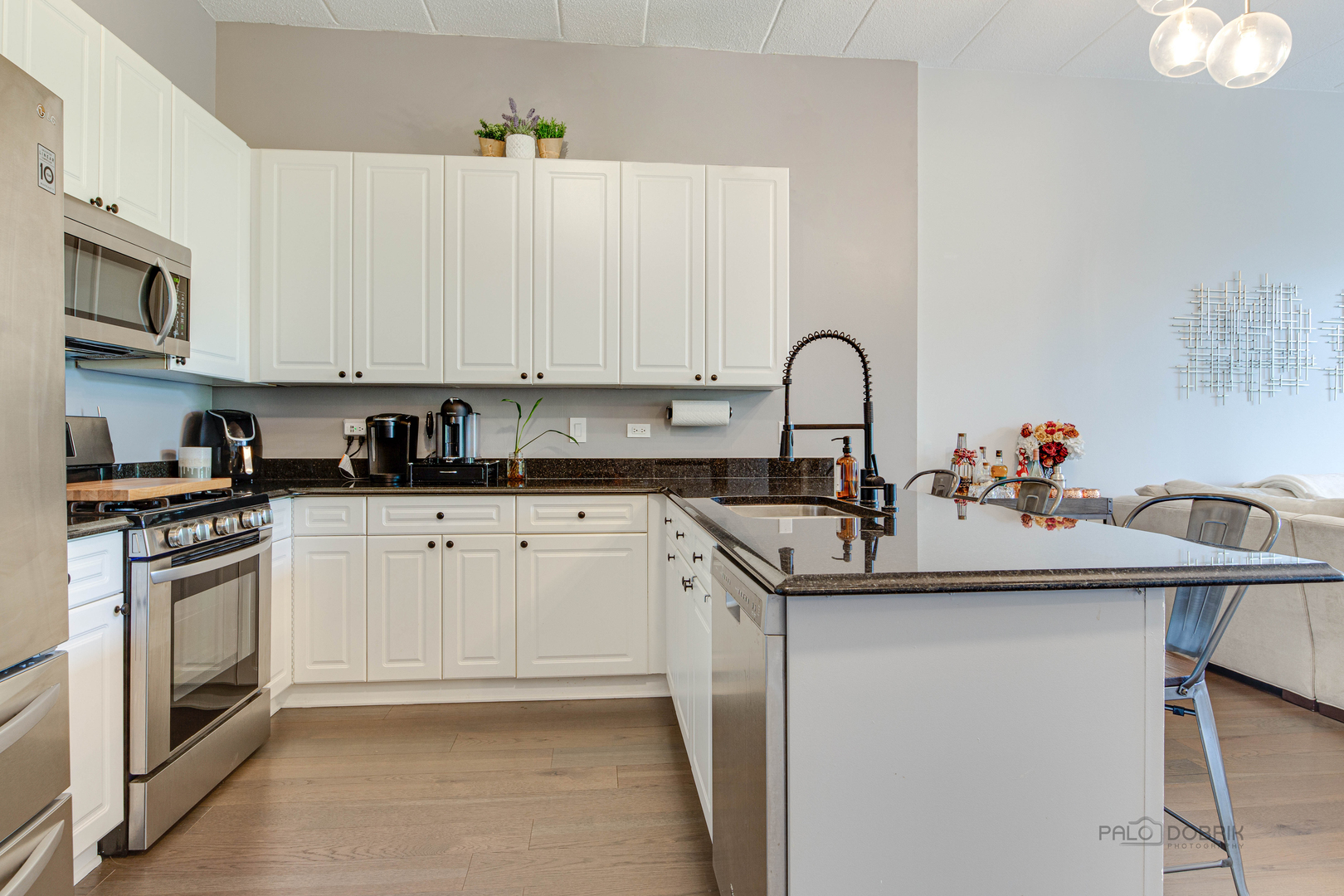 1301 West Washington Boulevard, Unit 309 Chicago, IL 60607 - Photo 6 of 23 a kitchen with stainless steel appliances granite countertop a sink and cabinets