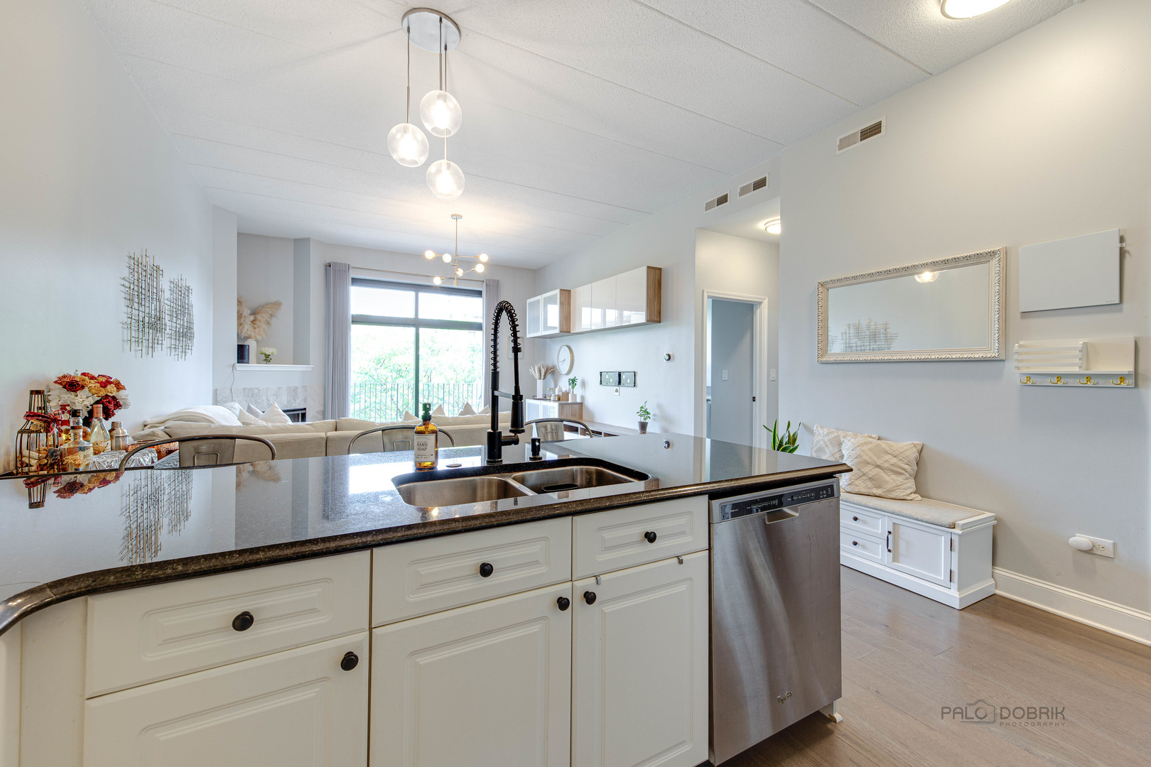 1301 West Washington Boulevard, Unit 309 Chicago, IL 60607 - Photo 7 of 23 a kitchen with kitchen island a sink appliances and cabinets