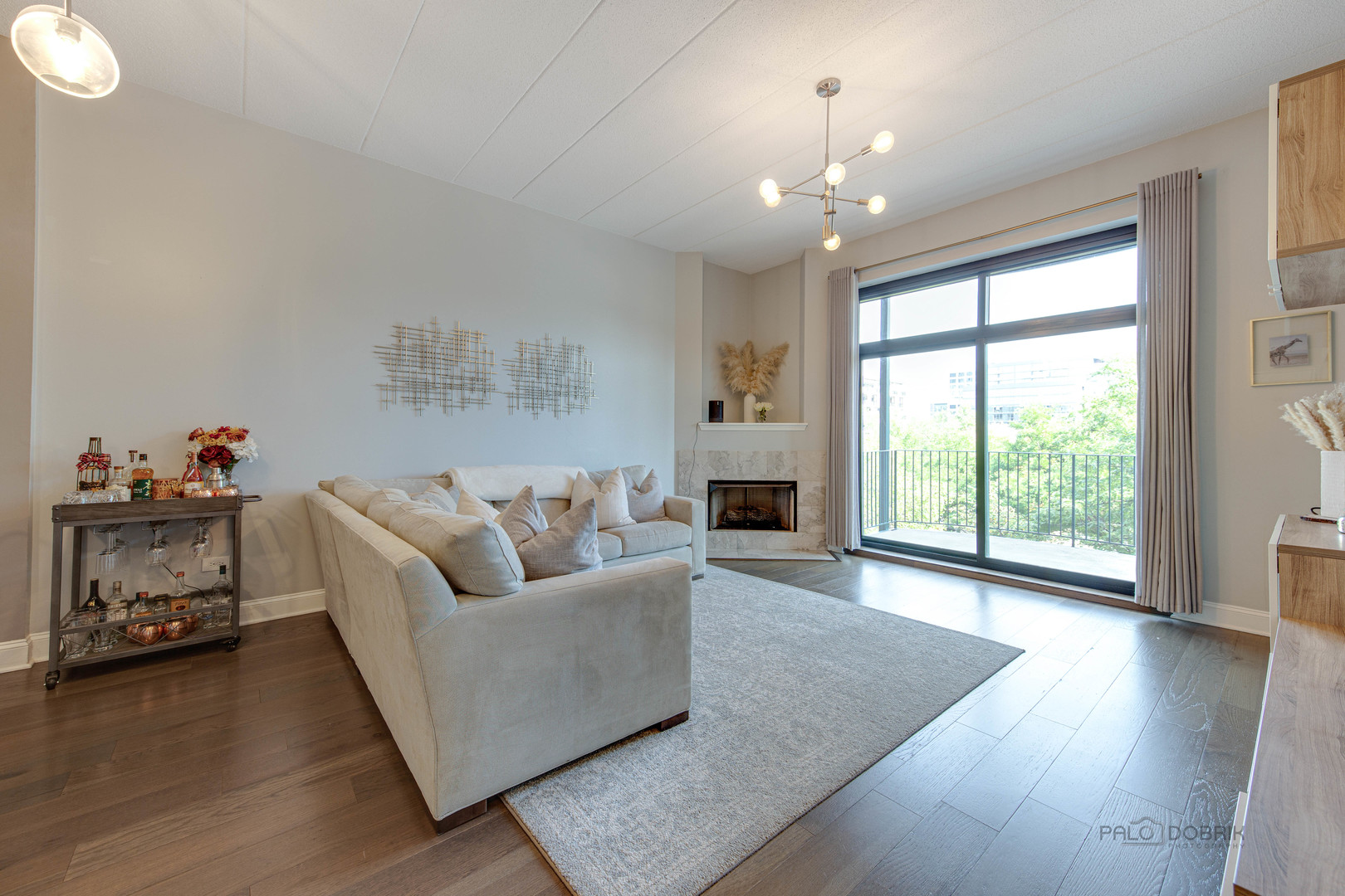 1301 West Washington Boulevard, Unit 309 Chicago, IL 60607 - Photo 9 of 23 a living room with furniture and a chandelier
