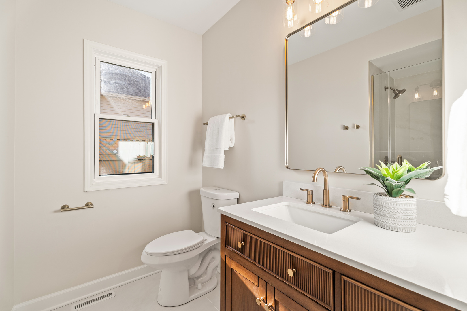 2817 Modaff Road Naperville, IL 60565 - Photo 14 of 43 a bathroom with a sink a toilet and a mirror