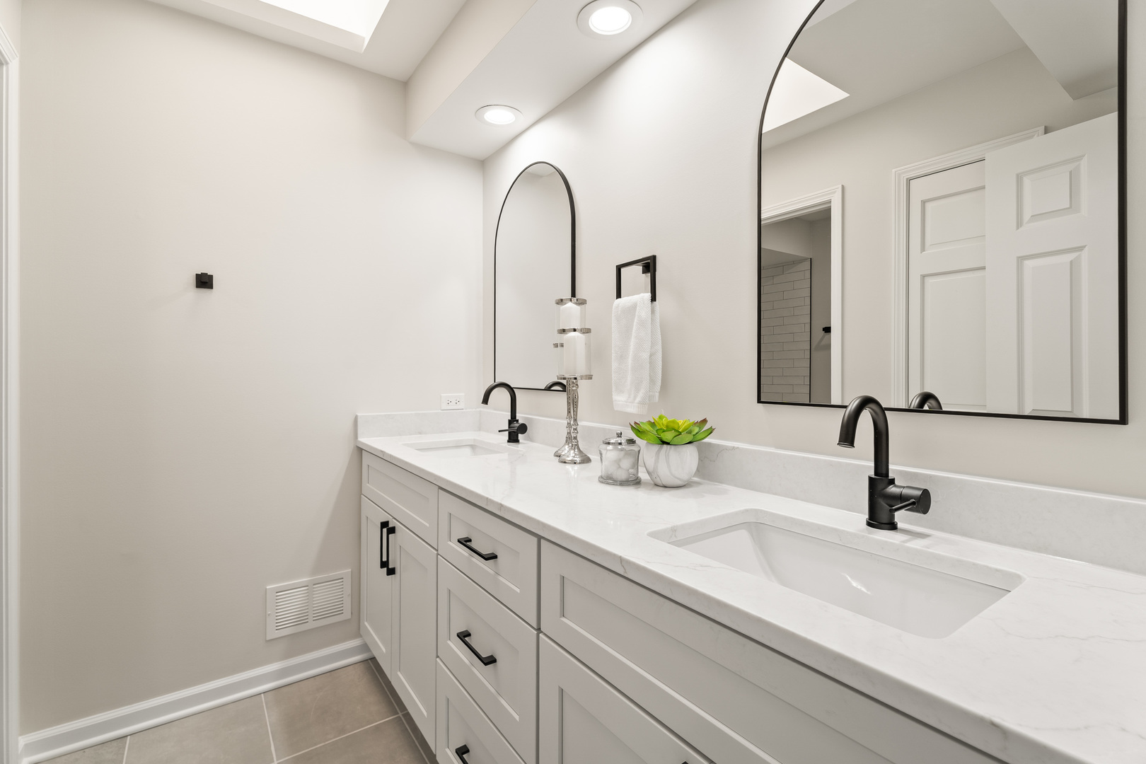 2817 Modaff Road Naperville, IL 60565 - Photo 24 of 43 a bathroom with double vanity sinks and a mirror