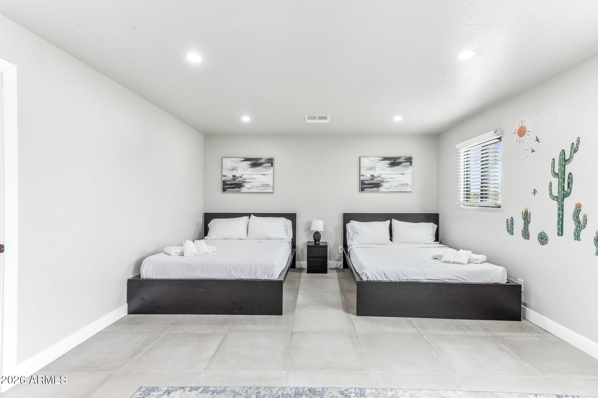 8725 East Osborn Road Scottsdale, AZ 85251 - Photo 12 of 33 a bedroom with a large bed and a couch