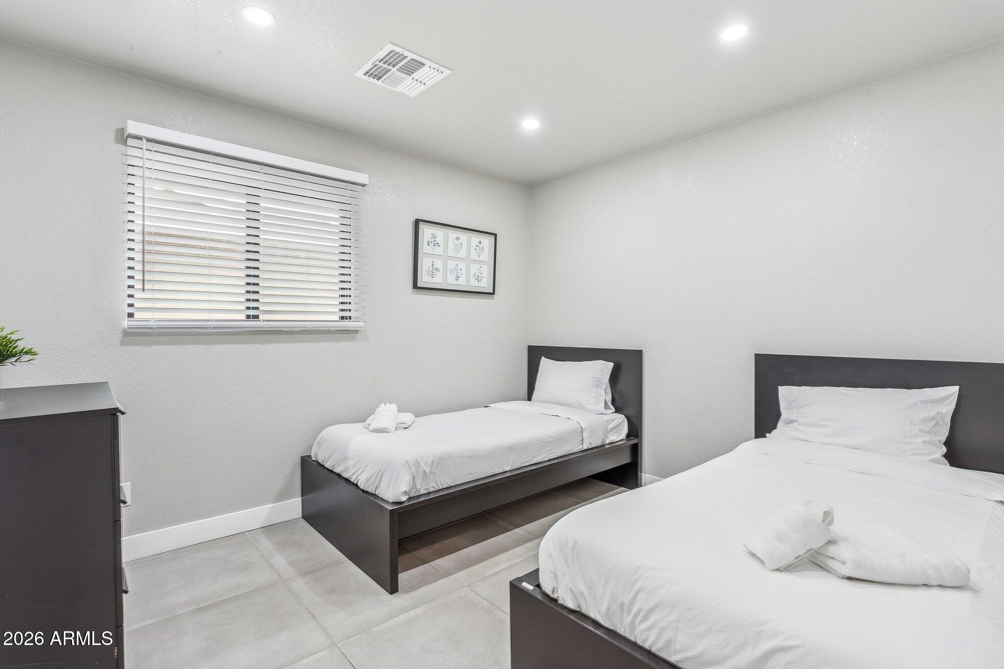 8725 East Osborn Road Scottsdale, AZ 85251 - Photo 18 of 33 a bedroom with two beds and a window