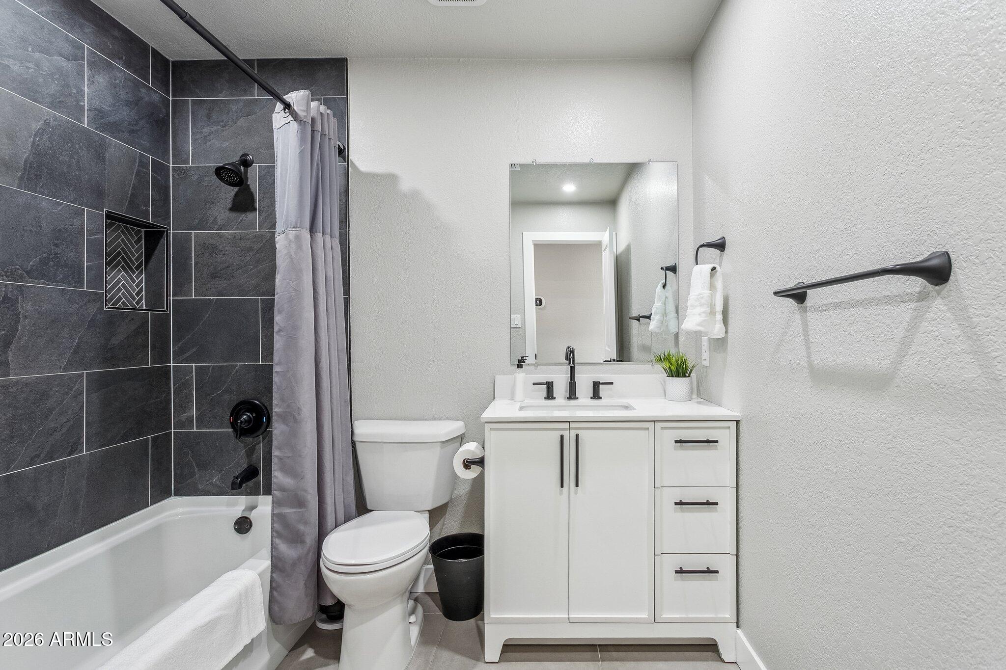 8725 East Osborn Road Scottsdale, AZ 85251 - Photo 21 of 33 a bathroom with a sink toilet and shower