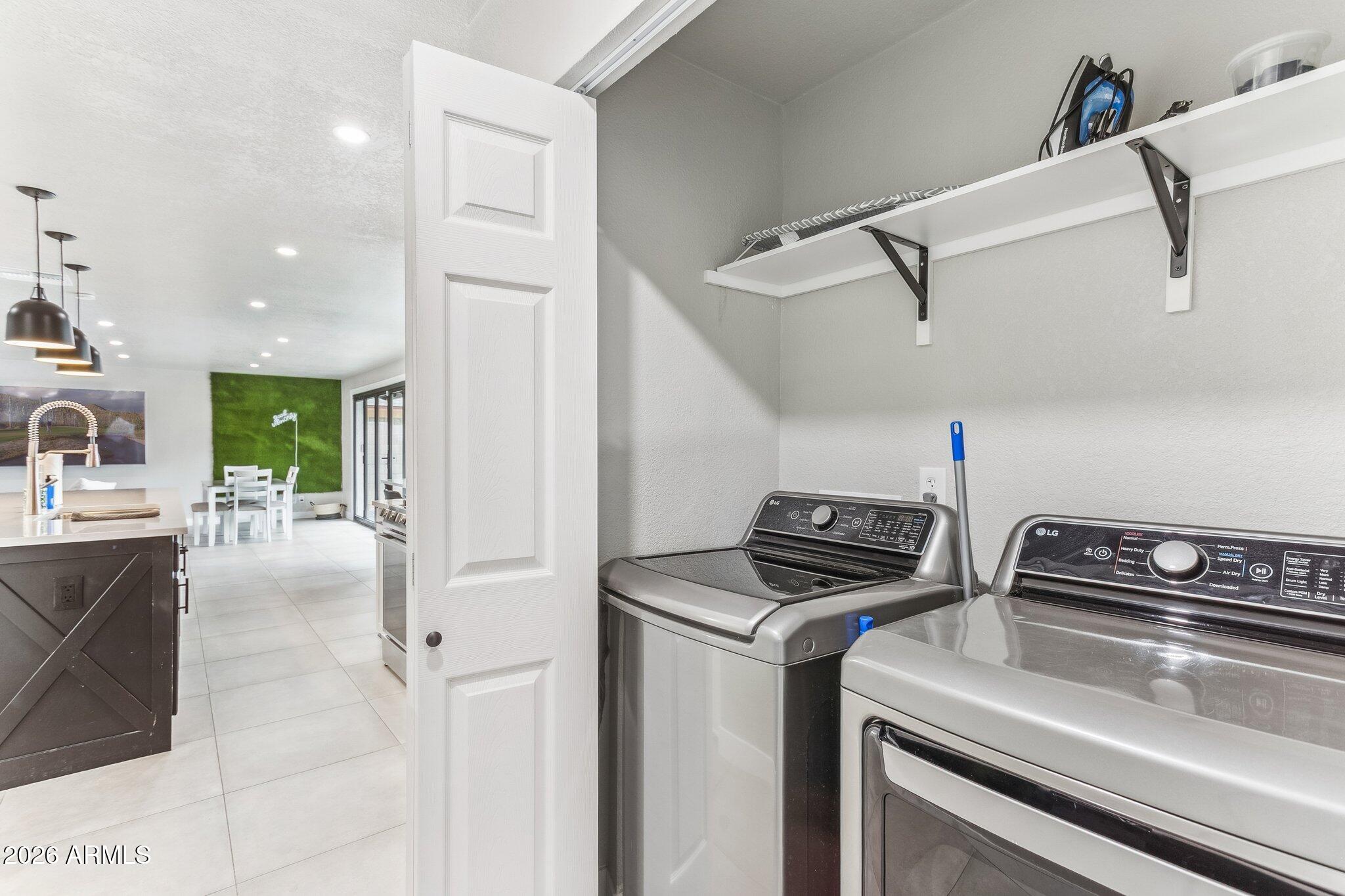 8725 East Osborn Road Scottsdale, AZ 85251 - Photo 22 of 33 a kitchen that has a stove and a refrigerator