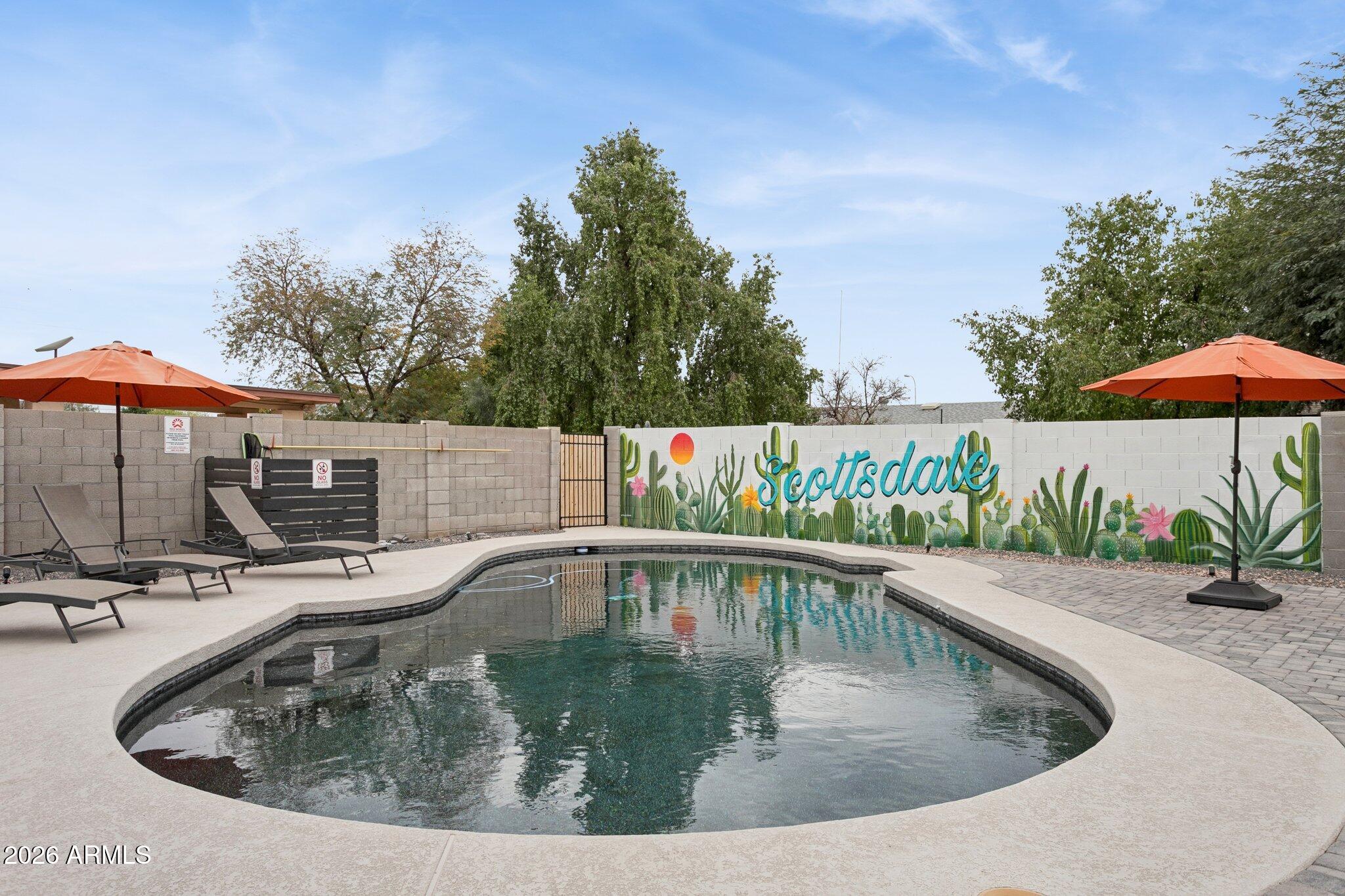 8725 East Osborn Road Scottsdale, AZ 85251 - Photo 23 of 33 a view of a swimming pool with a patio