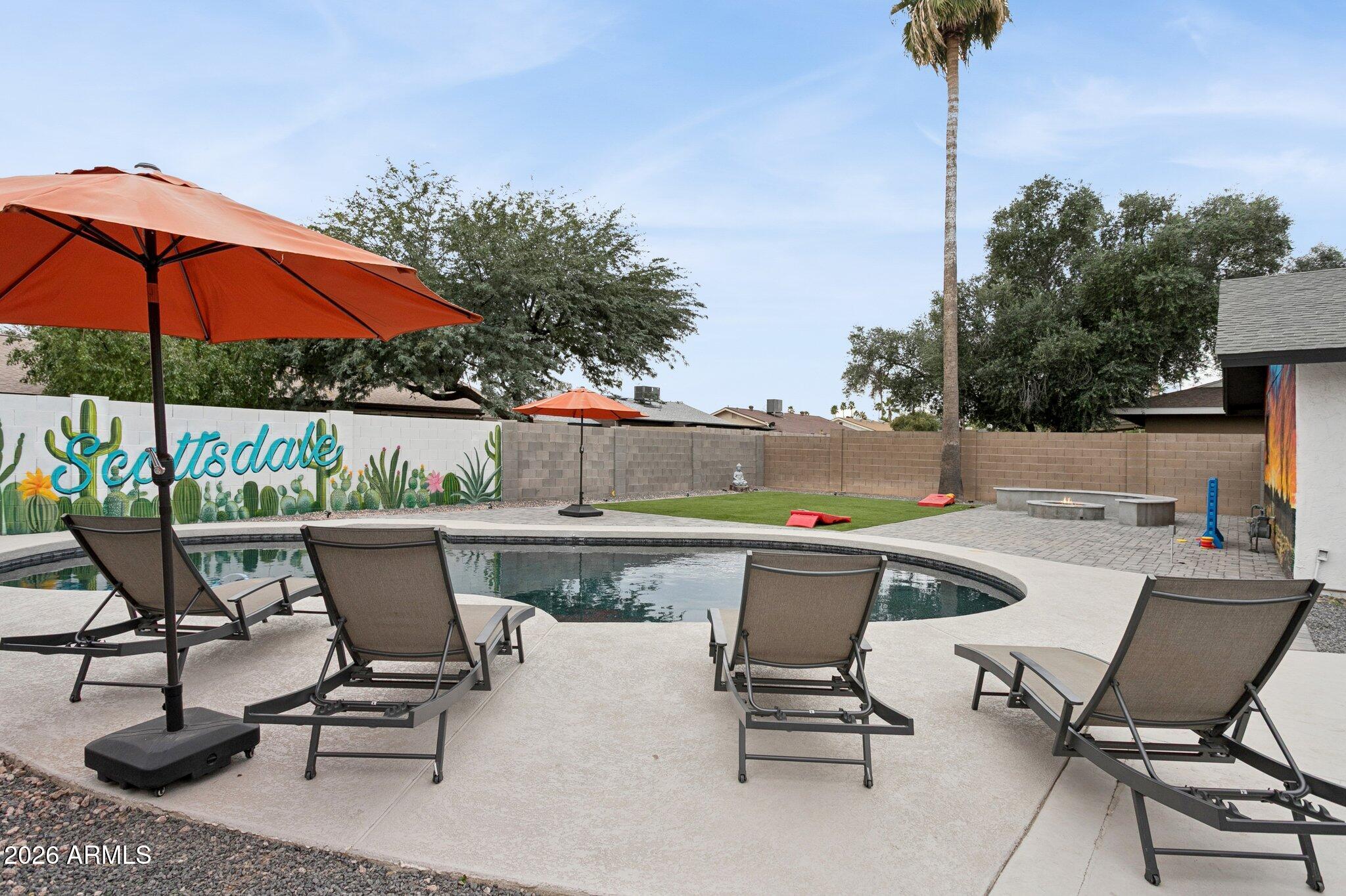 8725 East Osborn Road Scottsdale, AZ 85251 - Photo 24 of 33 a view of patio with a table and chairs under an umbrella