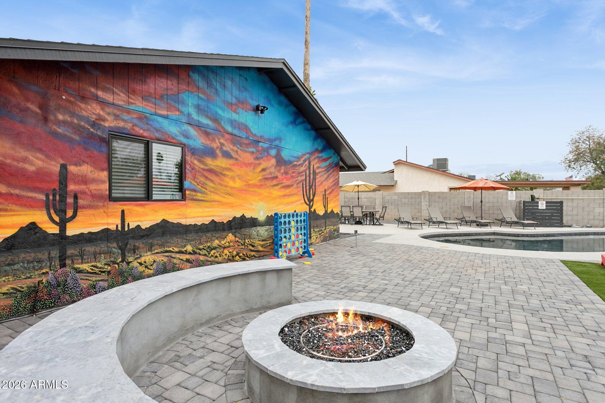8725 East Osborn Road Scottsdale, AZ 85251 - Photo 27 of 33 a view of a swimming pool with a lounge chairs