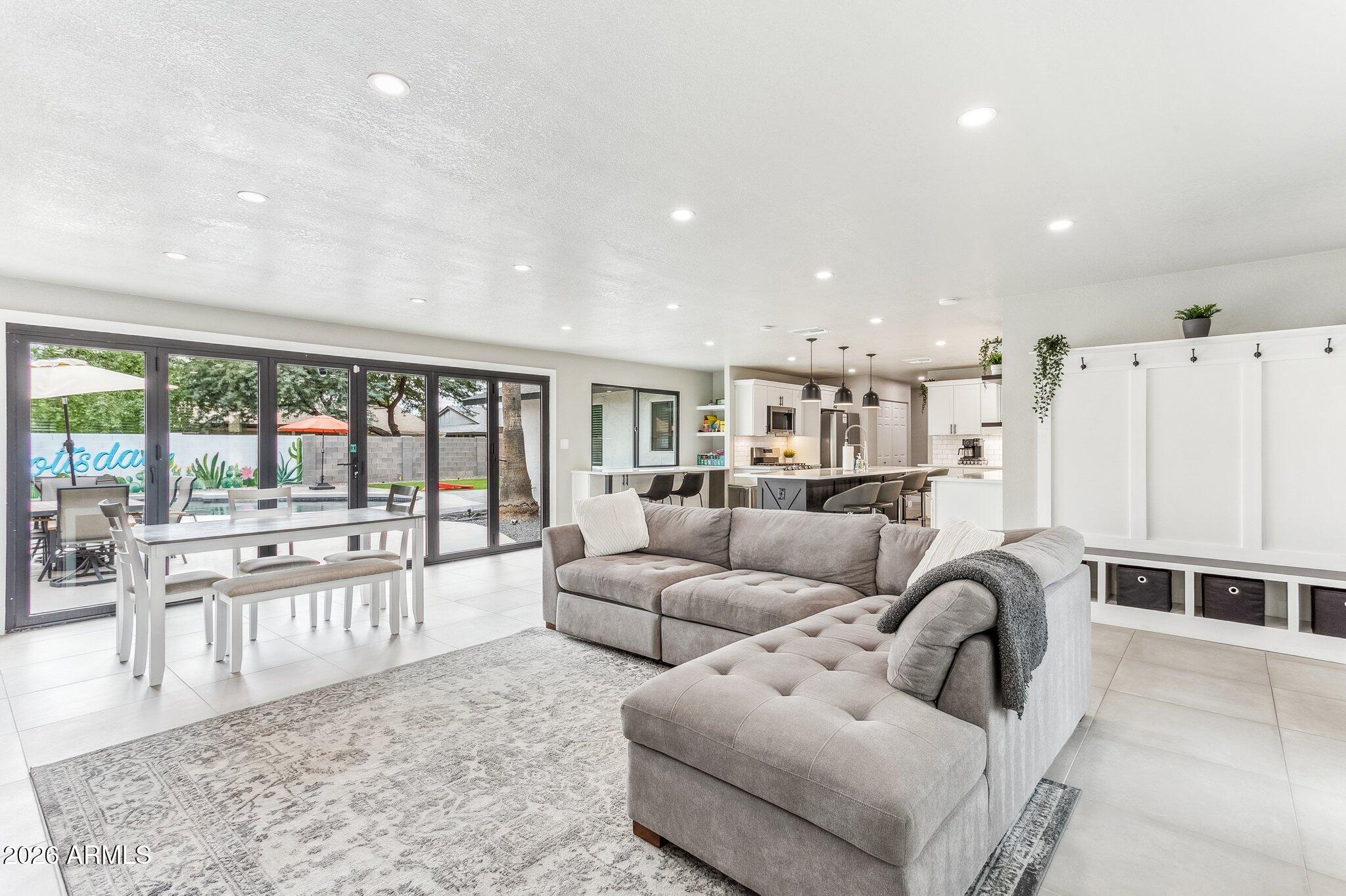 8725 East Osborn Road Scottsdale, AZ 85251 - Photo 2 of 33 a living room with furniture and a large window