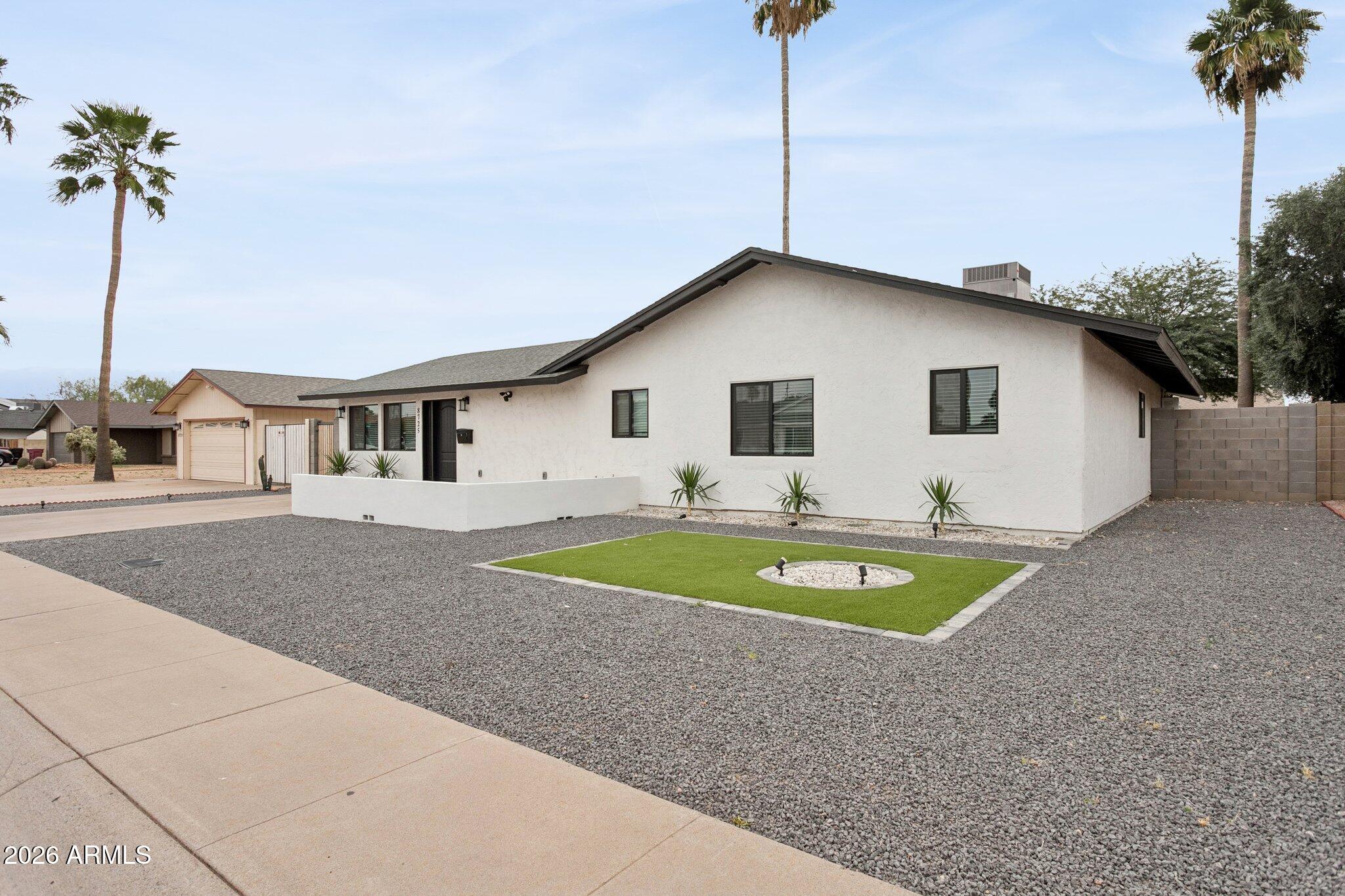 8725 East Osborn Road Scottsdale, AZ 85251 - Photo 30 of 33 a house with swimming pool in front of it