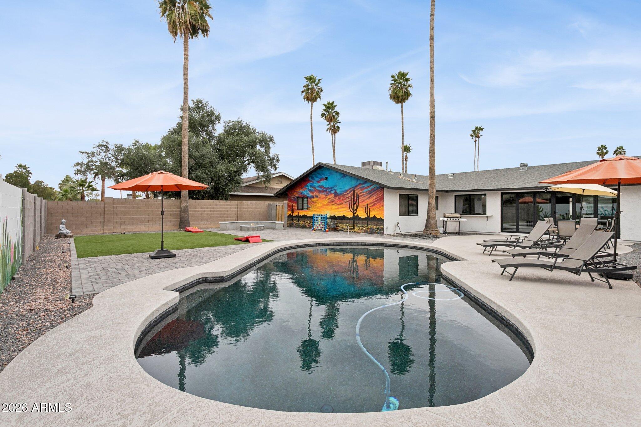8725 East Osborn Road Scottsdale, AZ 85251 - Photo 4 of 33 a view of a house with swimming pool