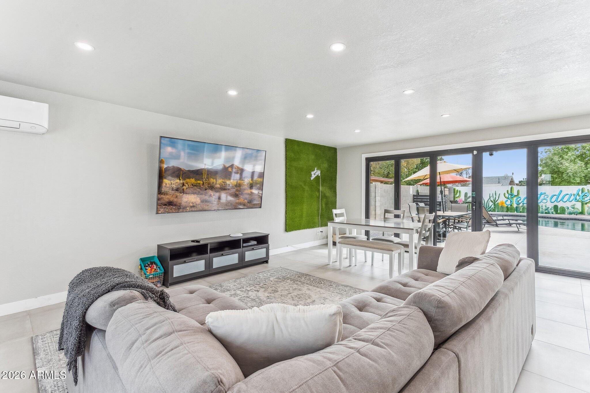 8725 East Osborn Road Scottsdale, AZ 85251 - Photo 7 of 33 a living room with furniture and a large window