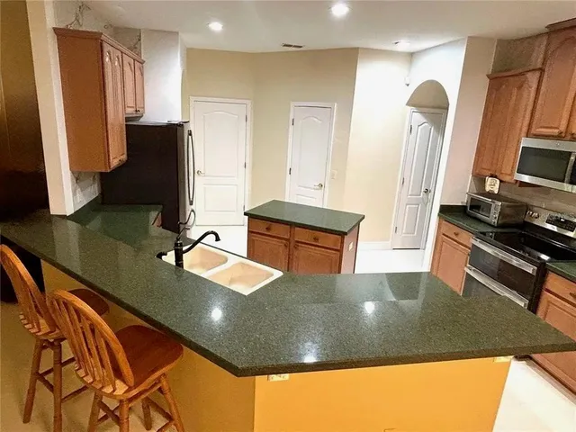 a view of a living room with furniture and a flat screen tv