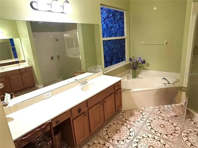 a bathroom with a bathtub sink and mirror