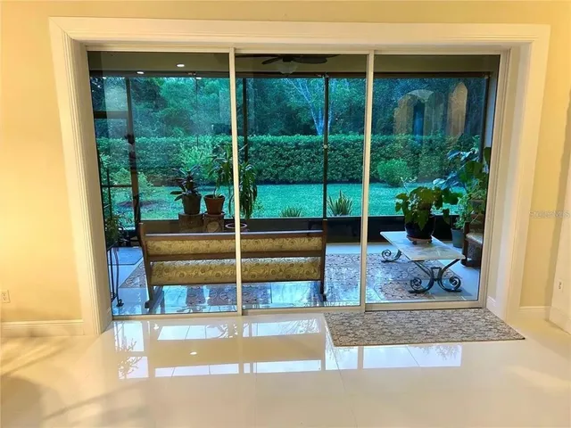 a living room filled with furniture and a potted plant
