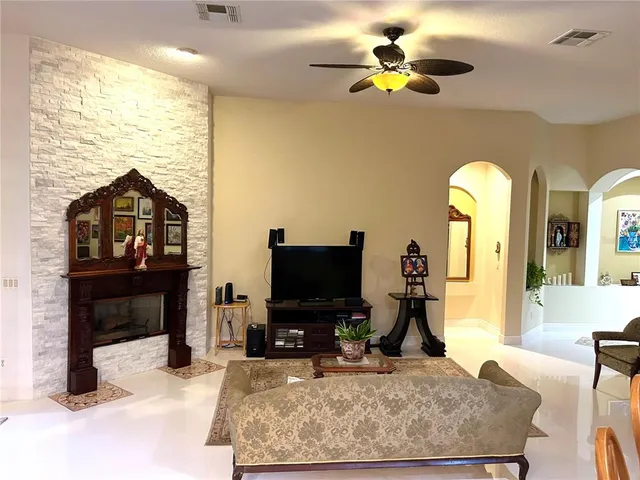 a living room with fireplace furniture and a flat screen tv