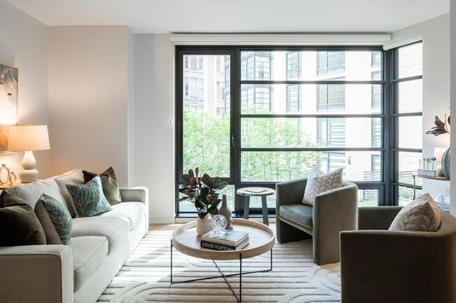 a living room with furniture and a potted plant