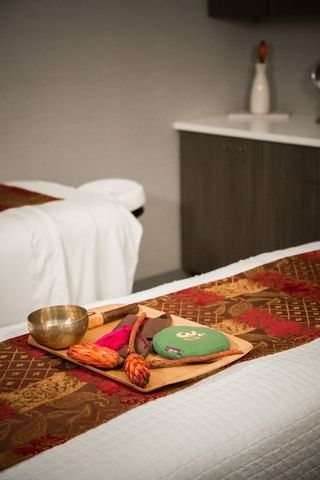 a bedroom with a bed and a potted plant