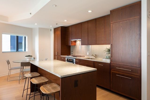 a kitchen with a sink cabinets and wooden floor