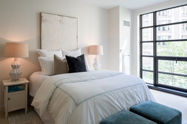 a bedroom with a bed and a window