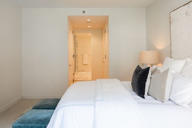 a bedroom with a bed and a mirror