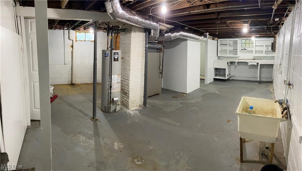 851 Springdale Street Akron, OH 44310 - Photo 13 of 22 Basement with gas water heater, heating unit, and sink