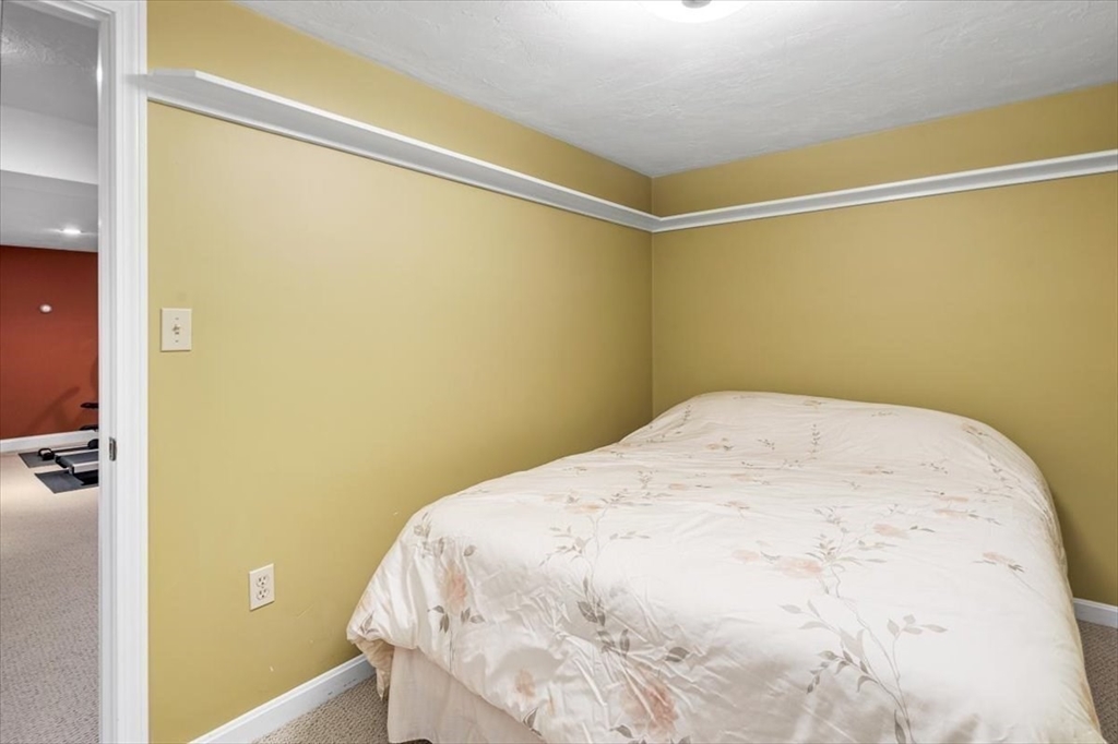 7 Peter Hobart Drive Hingham, MA 02043 - Photo 28 of 38 a bedroom with a bed and a wall painting