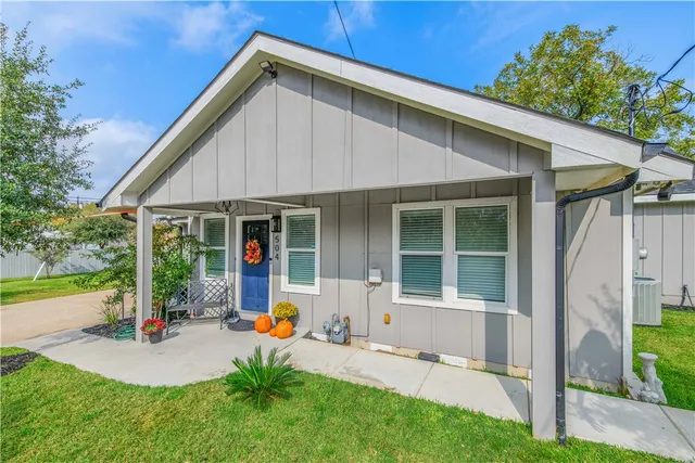a front view of house with yard and outdoor seating