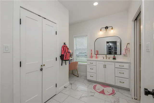 a bedroom with a bed a desk and chair