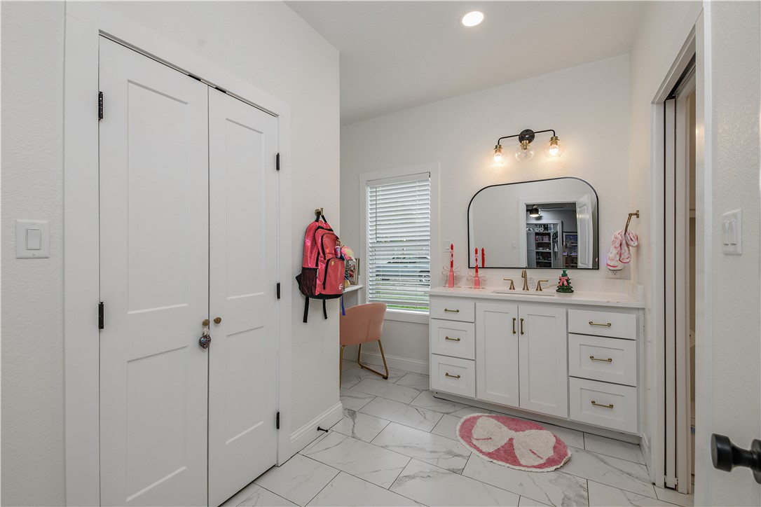 504 Eden Lane Bryan, TX 77803 - Photo 11 of 24 a bathroom with a sink and a mirror