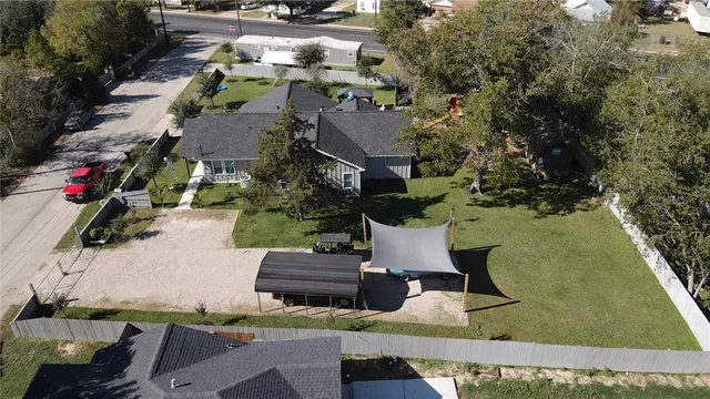 an aerial view of multiple houses with yard