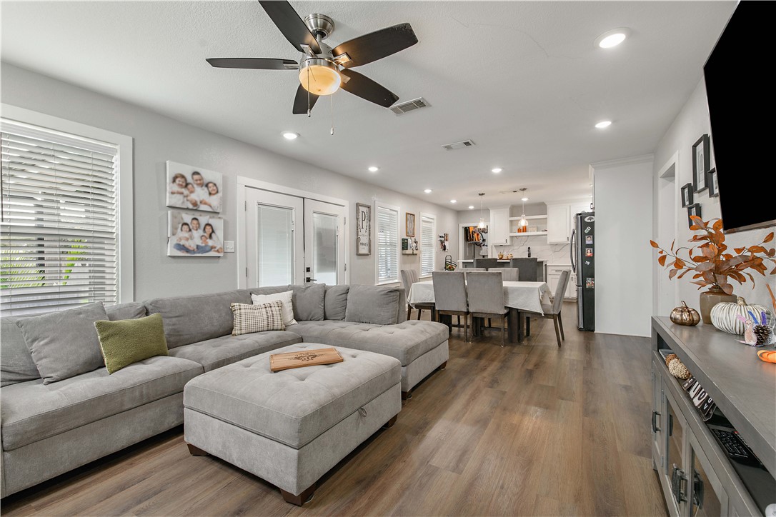 504 Eden Lane Bryan, TX 77803 - Photo 4 of 24 a living room with furniture and a flat screen tv with kitchen view