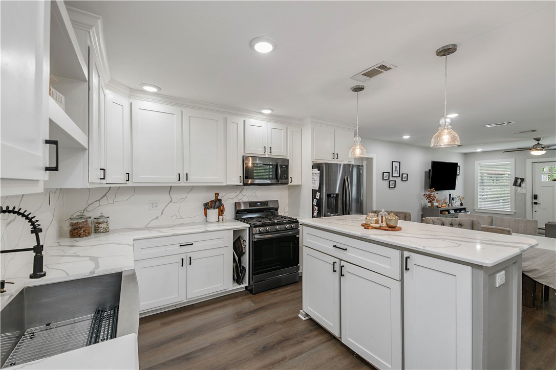 504 Eden Lane Bryan, TX 77803 - Photo 24 of 24 a kitchen with a sink stove and cabinets